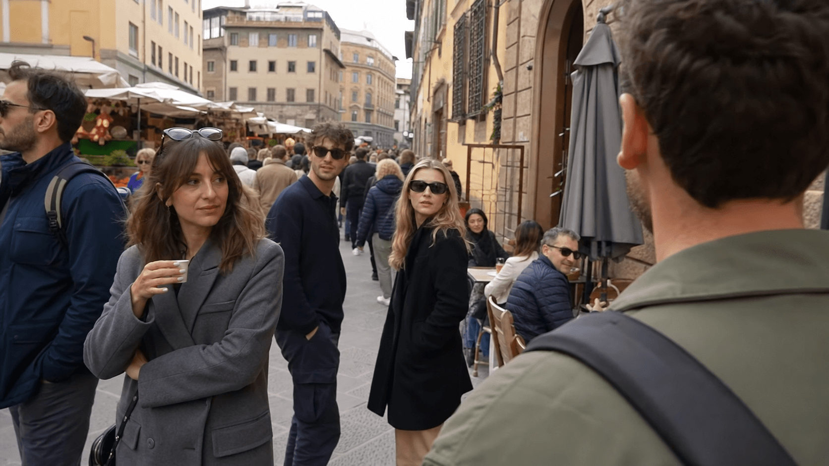 Walking-tour camera footage in a busy European market street